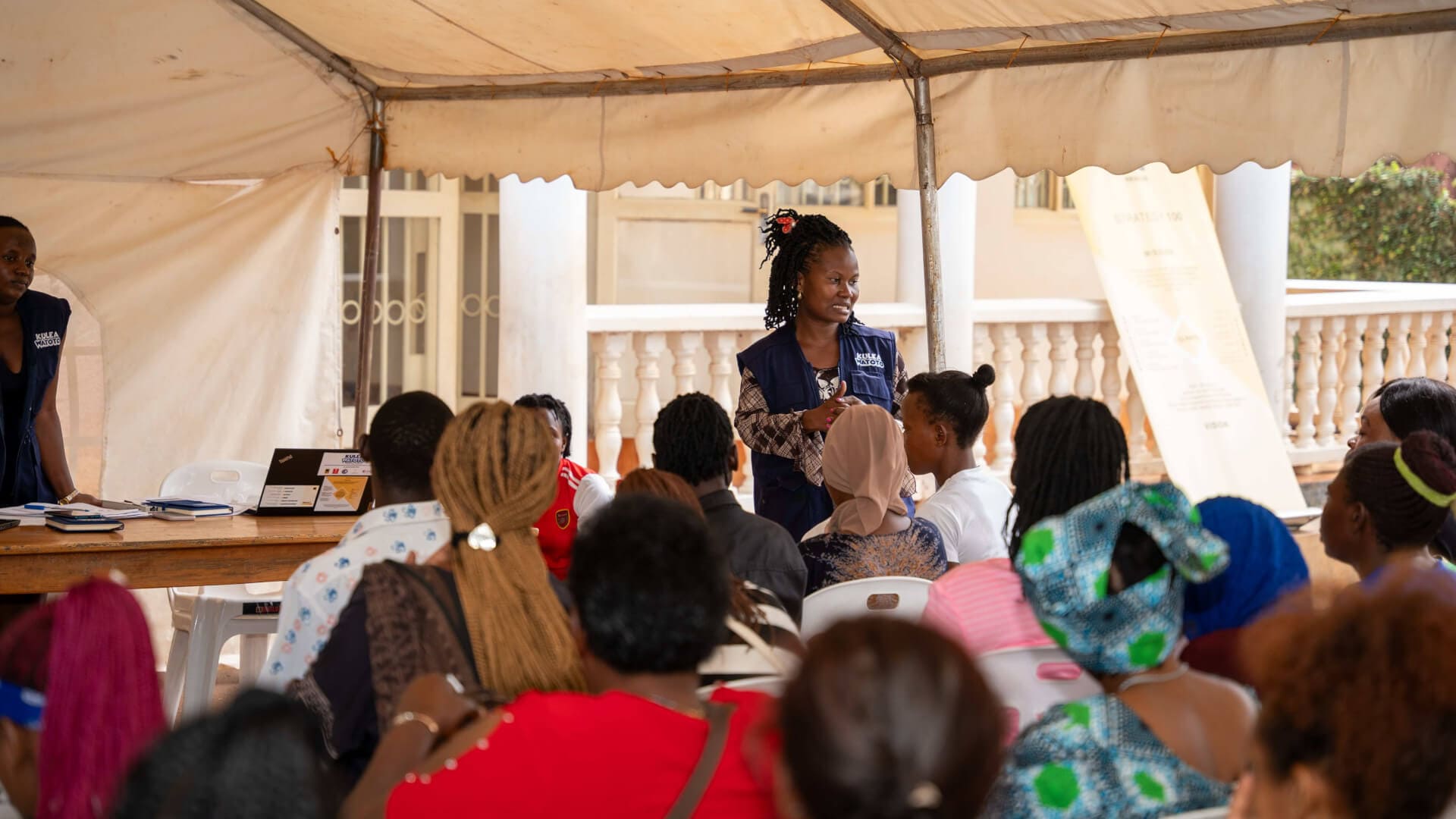 A Kulea Watoto project officer conducts a group dialogue on financial literacy ahead of the planned funds disbursement to clients enrolled under the project.