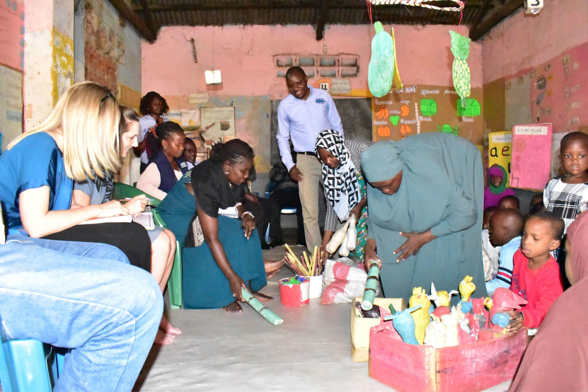 A team from IRC  interacts with caregivers and children at Kiti ECD and Nursery School during a recent visit to Kulea Watoto implementation sites in Kampala.