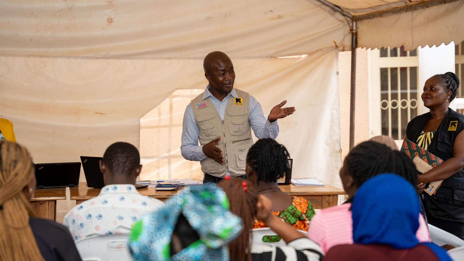 IRC Country Director interacts with clients from groups enrolled under the Kulea Watoto project. This was during a field visit in Makindye Division.