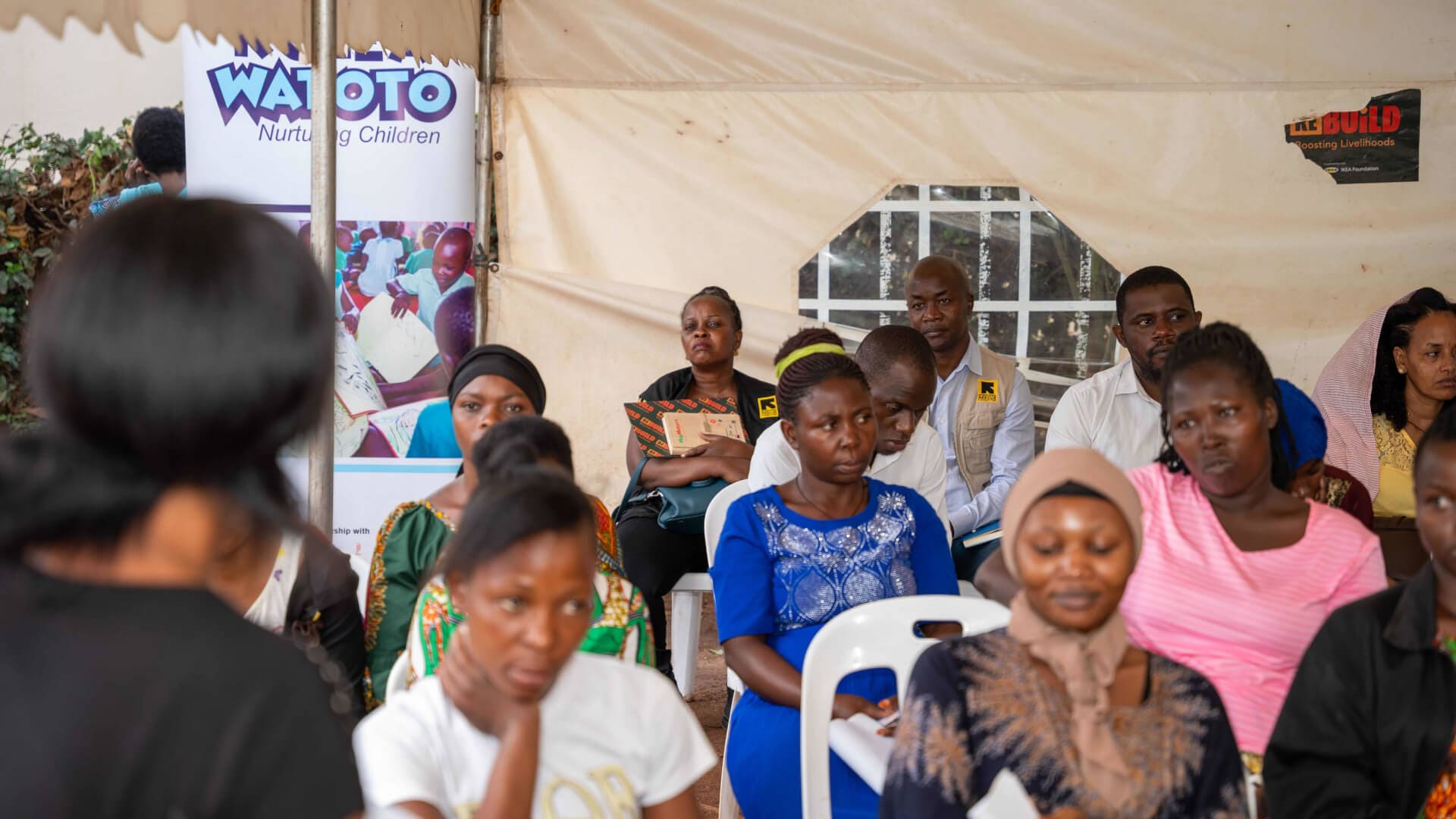 IRC Country Director listens to testimonies from clients under the Kulea Watoto project during a recently conducted field visit in Makindye Division, Kampala.