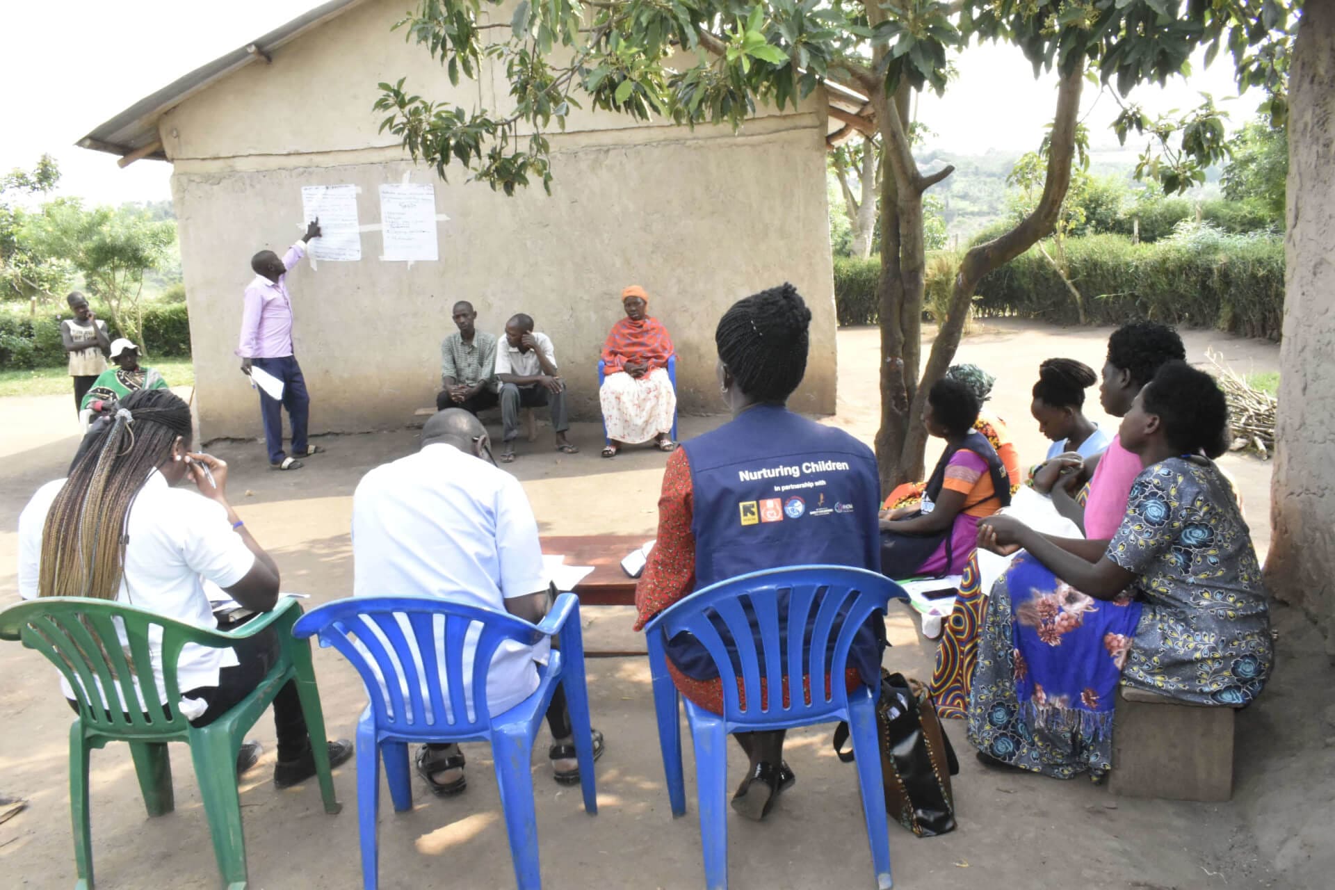 Kulea Watoto consortium members attend a session on infant care facilitated by the secretary of the Tukwatanise Group during a project field visit in Kyaka II refugee settement.