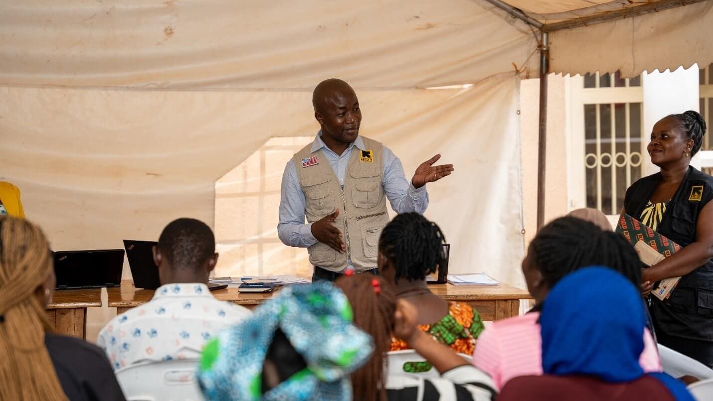 IRC Country Director interacts with clients from groups enrolled under the Kulea Watoto project during a field visit in Makindye Division