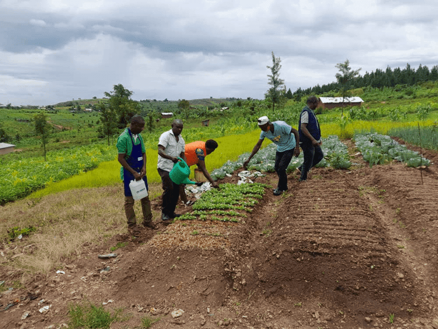 Enid Kyarisima inspects a demonstration garden at the Lucky Nursery School, an ECD Center in Kyaka II Refugee Settlement