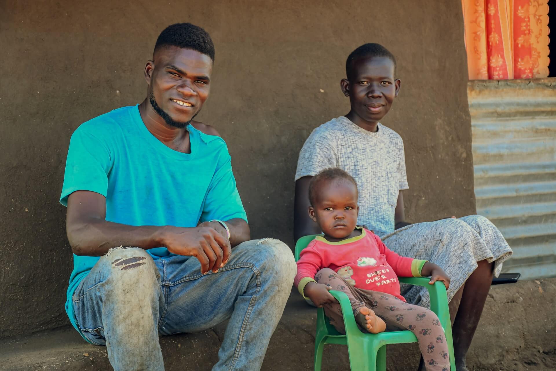 Phillip Ochan with his wife Betty and son Emmanuel at their home in Bidi Bidi Refugee Settlement. Thanks to trainings from Kulea Watoto, the young couple is hopeful for the future 