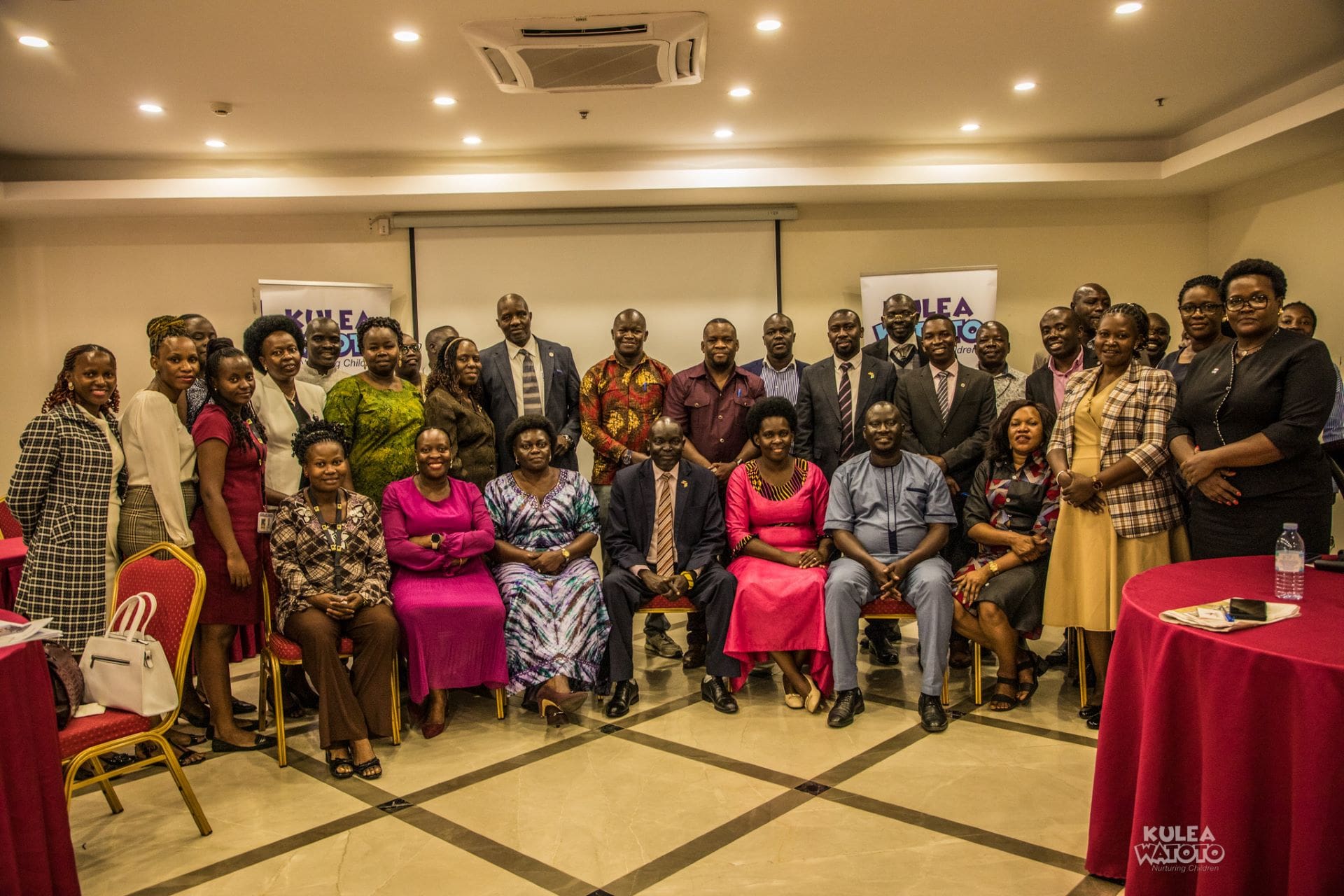 Members of Parliament together with Kulea Watoto Project Consortium partners pose for a group photo after a policy dialogue where a paper ‘Why Government of Uganda needs to prioritize Early Childhood Development’ was presented