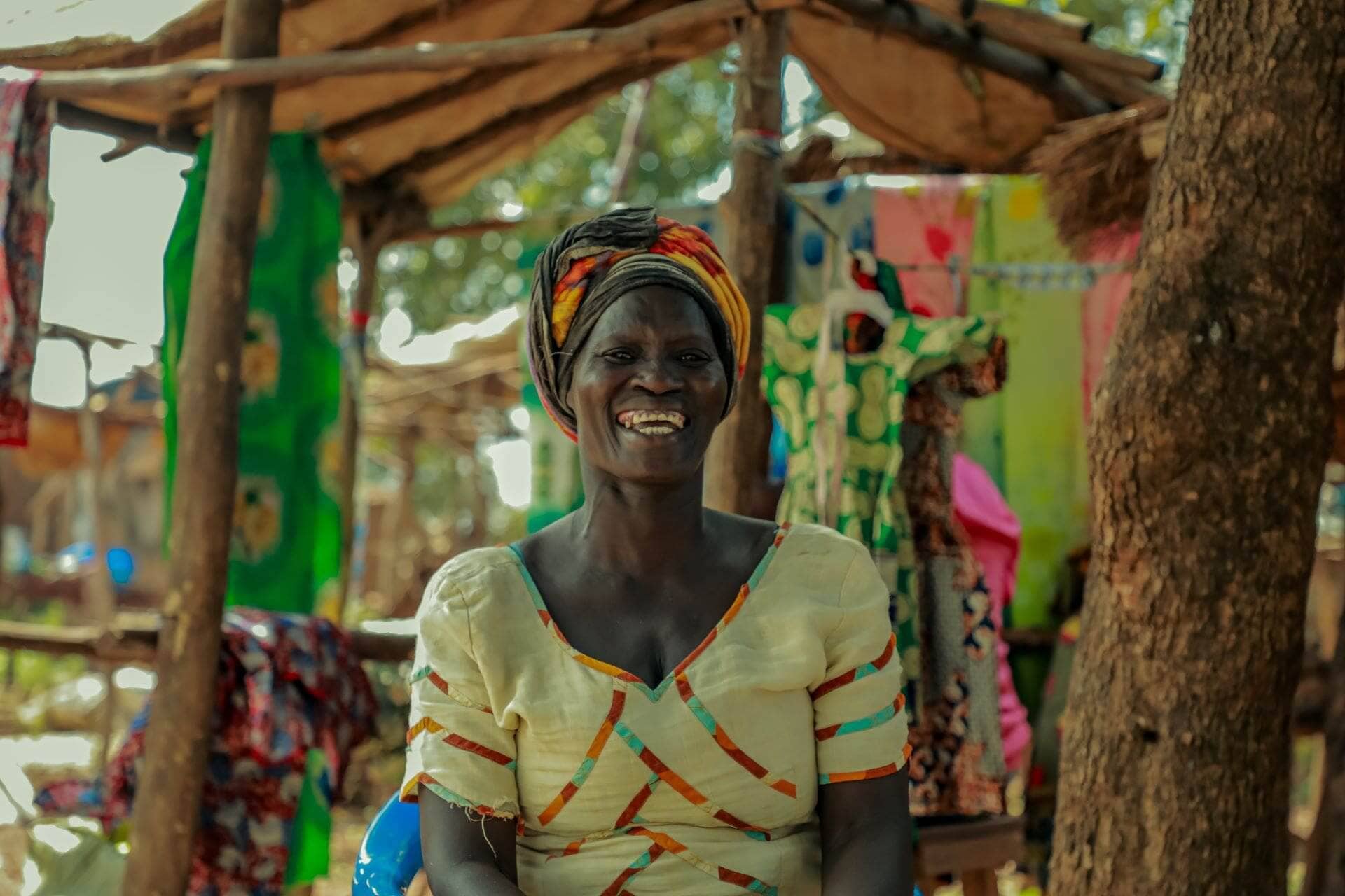 Rose Poni sits by her market stall. Through the Kulea Watoto Project, Poni‘s life has been transformed and she is able to provide for her basic needs and those of her young daughter