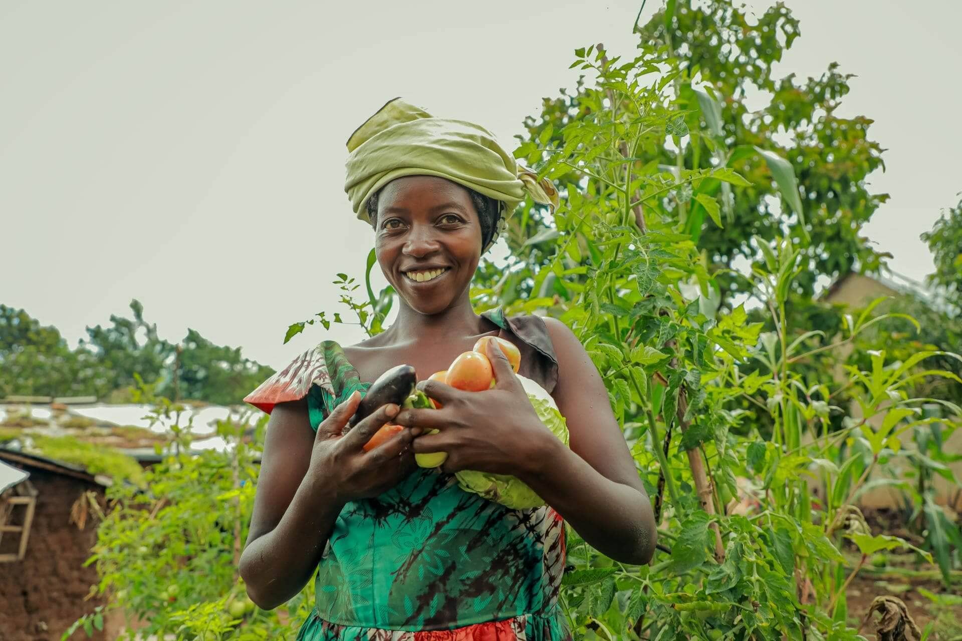 Jeanette Mukarukunda holds fresh vegetables from her home garden. The Kulea Watoto Project offers training and agricultural tools to help build sustainable livelihoods for both refugees and host communities