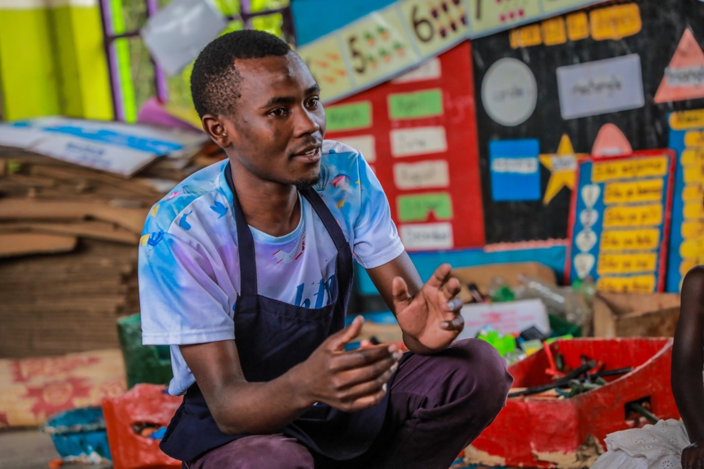 Benon Gumisiriza, a caregiver at Lucky Early Learning Center in Kyaka II Refugee Settlement conducts a learning session in his class