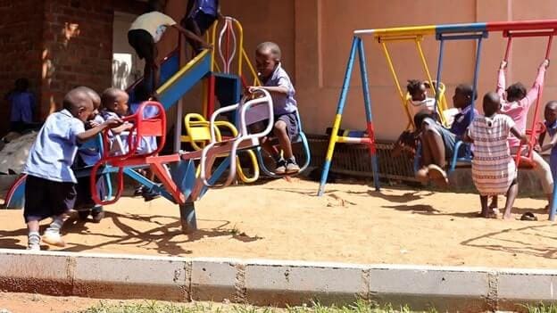 Children play at one of the play spaces supported by the Kulea Watoto Project in Konge, Makindye Division