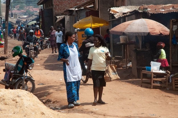 Margaret Nakavuma Kisakye, a trained Village Health Team (VHT) member (right), interacts with Scovia Kyalisima (left), a beneficiary under the Kulea Watoto Programme in Nsambya, Makindye division