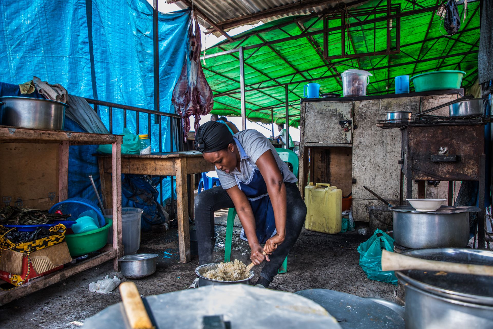 Determined! Munezero prepares posho popularly known as ugali inside her kitchen. Munezero’s restaurant serves cuisines to refugees from Burundi, Rwanda and DR Congo whilst employing both nationals and refugees