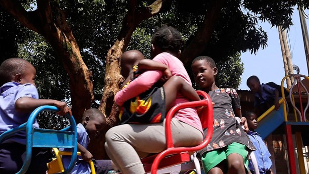 Children play at one of the play spaces established by the Kulea Watoto Project in Konge, Makindye Division