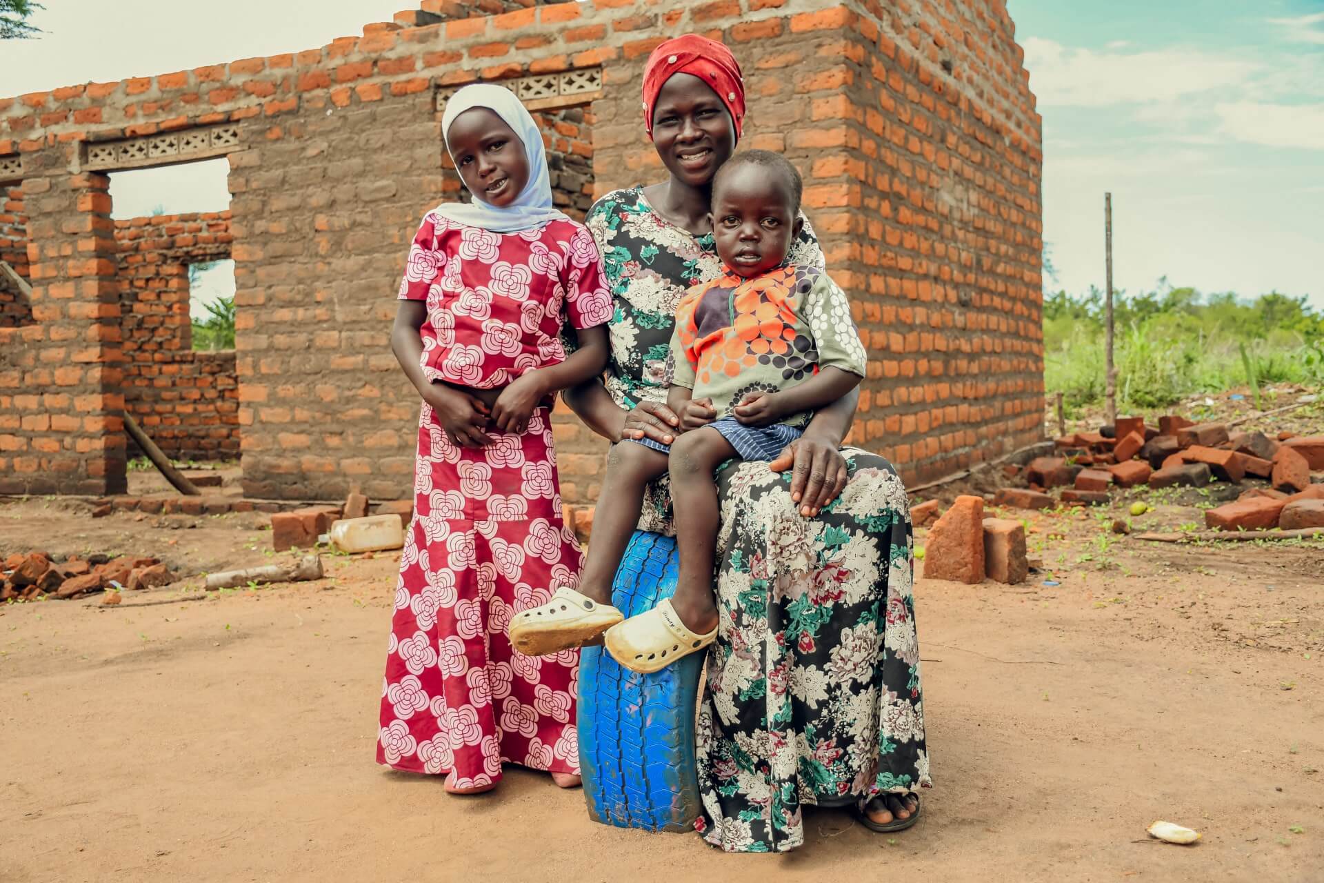 Asna Gadai with her children who go to Limika Home Learning Center. Asna is proud of the work at the learning center that provides affordable learning for her children, in an area that is close to her home