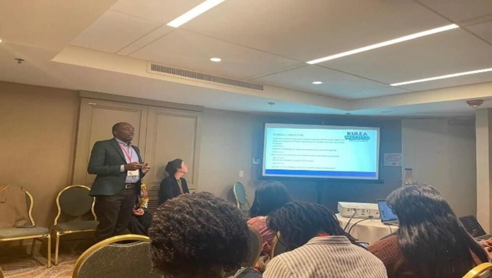Godfrey Mwesigye, Senior Policy and Advocacy Manager for Kulea Watoto making a presentation at CIES in Chicago - Kulea Watoto