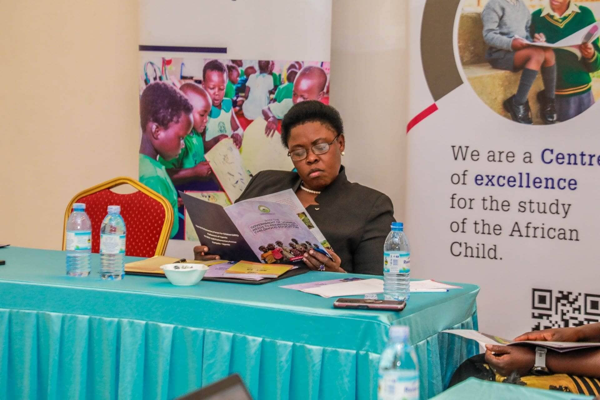 The Chairperson of the Parliamentary Forum for Children, Hon. Margaret Makokha, hands over a copy of the Issues Paper on ‘Why Government of Uganda needs to Prioritize Early Childhood Development’ to Hon. Min. Joyce Kaducu. (Photo by Jonathan Ssekitondo for the IRC)