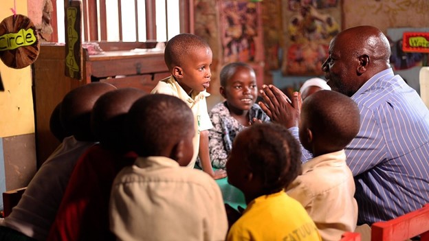 Kiberu Hassan, Chairperson (CMC), interacting with learners at Kiti Nursery School in Katwe, Kampala Central