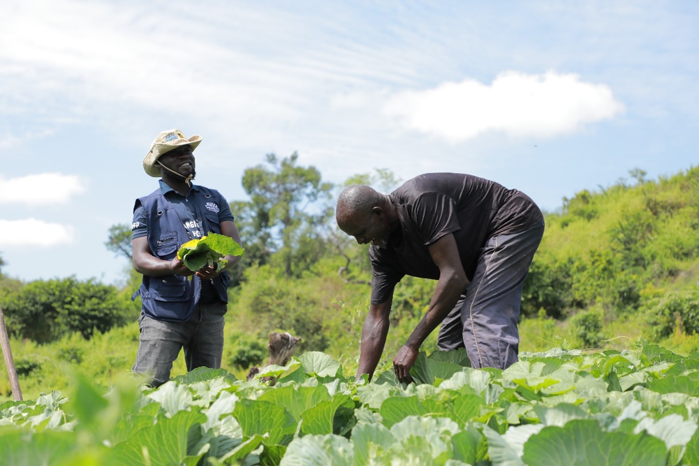 Mike Arimadri, the ERD Officer the International Rescue Committee shares a light moment with Jafar in his garden. Jafar is proud of the support Kulea Watoto has given them along the way to self-reliance through horticulture